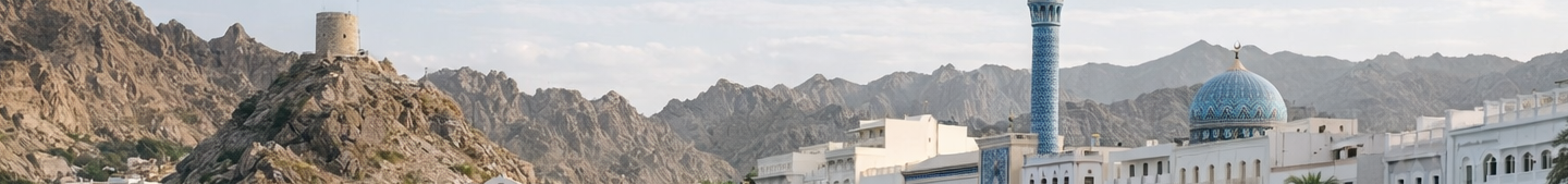 Modern industrial building with a sleek blue and white exterior under a partly cloudy sky.
